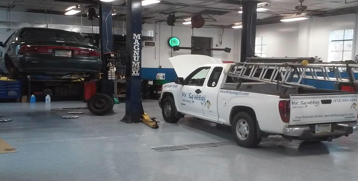 Two Vehicles Being Worked on